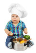 Photo: Little boy in chef's hat with pan and vegetables, isolated Little boy in chef's hat with pan and vegetables, isolated
