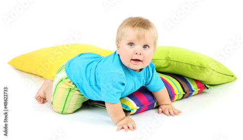 Photo: Little boy and color pillows, isolated on white Little boy and color pillows, isolated on white
