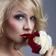 close-up portrait of beautiful blonde woman with red - white ros
