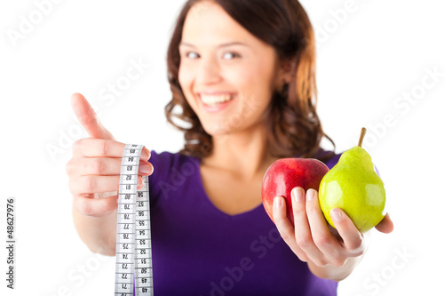 Photo: Woman with apple, pear and measuring tape Woman with apple, pear and measuring tape