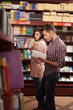 young guy reading in bookstore