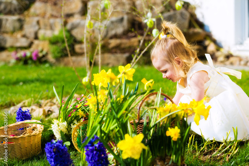 Photo: Girl on Easter egg hunt with eggs Girl on Easter egg hunt with eggs