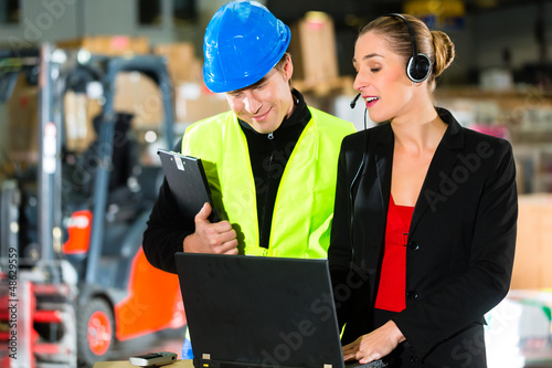 Photo: Coworkers at warehouse of forwarding company Coworkers at warehouse of forwarding company