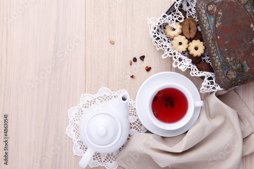 Photo: wooden table for breakfast with teapot cup of tea and biscuits wooden table for breakfast with teapot cup of tea and biscuits