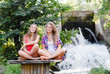 Two teen girls sitting in yoga position