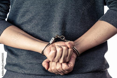 Photo: Arrested man handcuffed hands at the back Arrested man handcuffed hands at the back
