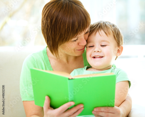 Photo: Mother is reading book for her son Mother is reading book for her son