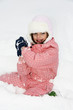 a little girl playing with snow
