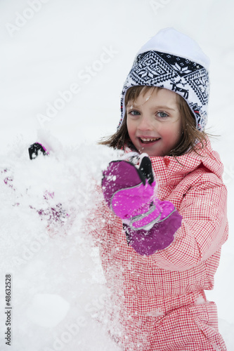 Photo: little girl playing with snow - winter little girl playing with snow - winter