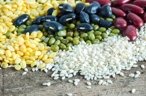 Photo: bean and white sesame seeds pile on wood bean and white sesame seeds pile on wood