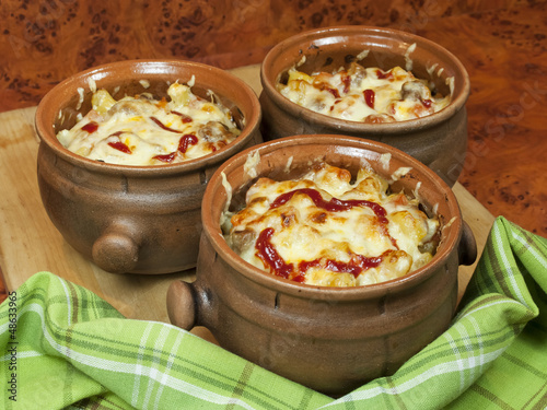 Photo: Meat and vegetables with cheese and ketchup in pots Meat and vegetables with cheese and ketchup in pots