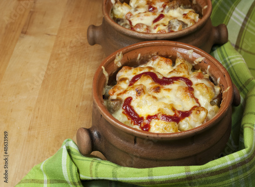 Photo: Meat and vegetables with cheese and ketchup in pots Meat and vegetables with cheese and ketchup in pots