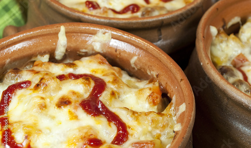 Photo: Meat and vegetables with cheese and ketchup in pots Meat and vegetables with cheese and ketchup in pots