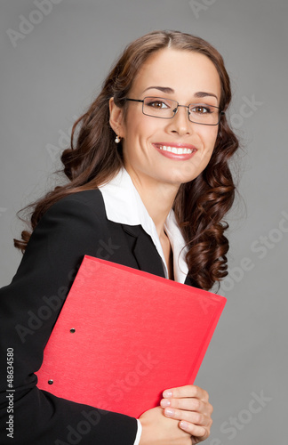 Photo: Businesswoman with folder, on gray Businesswoman with folder, on gray