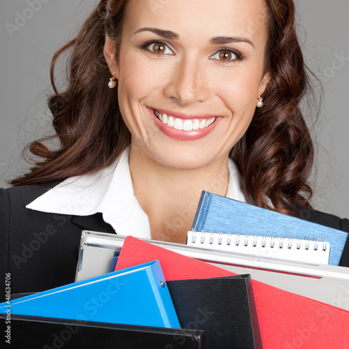 Photo: Businesswoman with folders, on gray Businesswoman with folders, on gray
