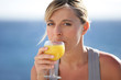 Woman drinking a glass of orange juice
