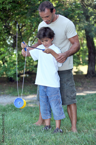 Photo: Father playing with son with a diabolo Father playing with son with a diabolo
