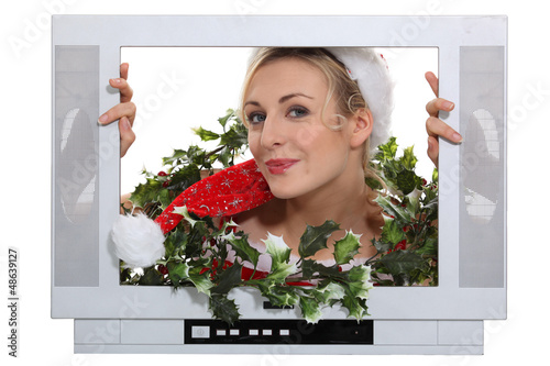 Photo: Woman in festive outfit escaping from television Woman in festive outfit escaping from television