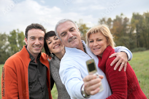 Photo: Family taking pictures in the countryside Family taking pictures in the countryside