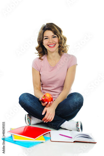 Photo: Young pretty female student with red apple isolated on white Young pretty female student with red apple isolated on white