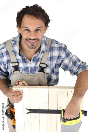 Photo: Carpenter with a saw Carpenter with a saw