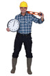 craftsman holding a clock and a level