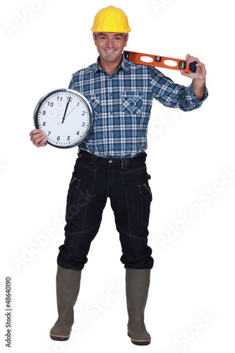 Photo: craftsman holding a clock and a level craftsman holding a clock and a level