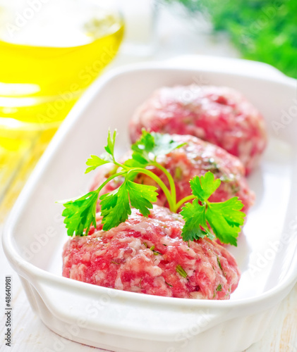 Photo: Raw meat balls in the white bowl Raw meat balls in the white bowl