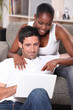 Photo: mixed couple surfing the net mixed couple surfing the net