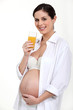 Pregnant woman drinking a glass of juice