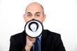 A businessman with a loudhailer.