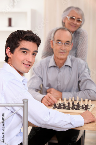 Photo: Grandfather and grandson playing chess Grandfather and grandson playing chess