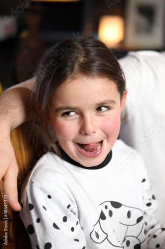 Photo: Young girl sticking out her tongue Young girl sticking out her tongue