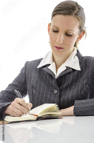 Photo: Businesswoman writing in her notepad Businesswoman writing in her notepad