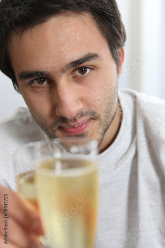 Photo: Man holding glass of champagne Man holding glass of champagne