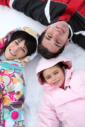 Photo: Family lying in the snow Family lying in the snow