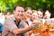 In Beer garden - friends drinking beer