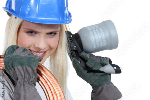 Photo: Blond woman with blowtorch and copper pipe Blond woman with blowtorch and copper pipe