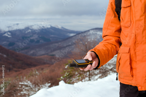 Photo: Backpacker holding in his hand GPS Backpacker holding in his hand GPS