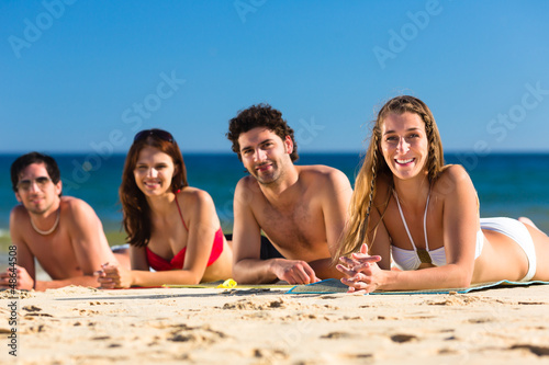 Photo: Friends on beach vacation in summer Friends on beach vacation in summer