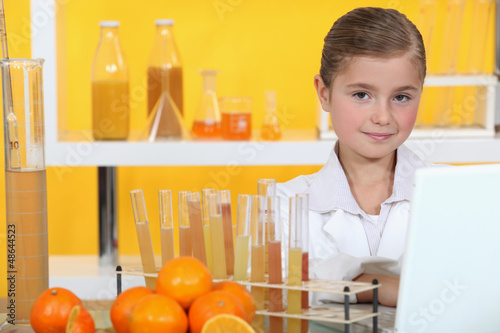 Photo: Girl analysing juice Girl analysing juice