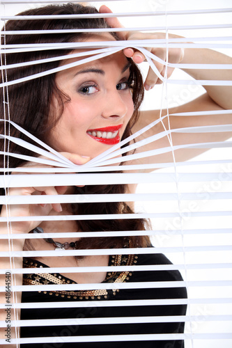 Photo: sexy woman looking through the blinds sexy woman looking through the blinds