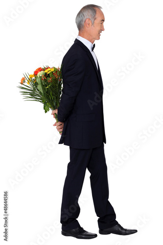 Photo: Man in an evening suit with a bouquet of flowers Man in an evening suit with a bouquet of flowers