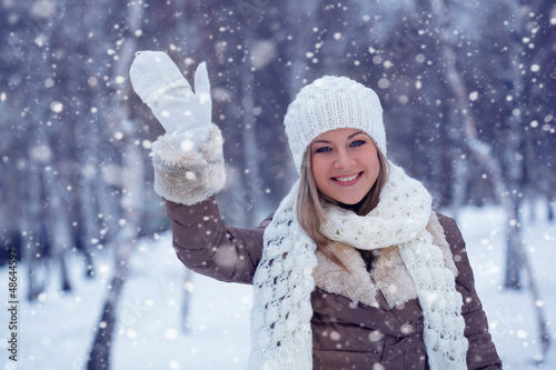 Photo: woman waving in winter park woman waving in winter park