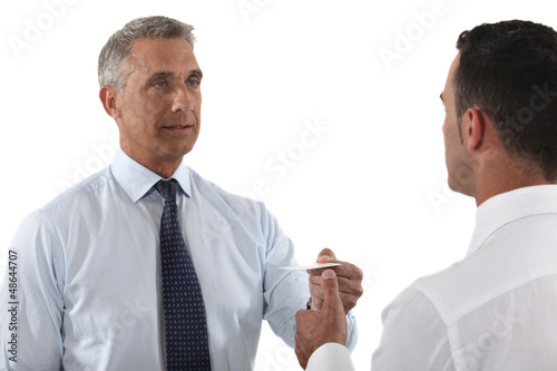 Photo: Executives exchanging business cards Executives exchanging business cards