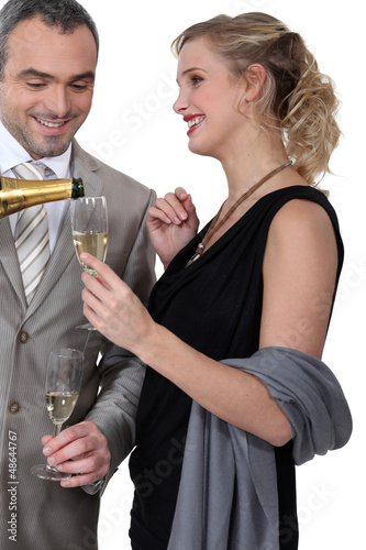 Photo: Glamourous couple drinking champagne Glamourous couple drinking champagne
