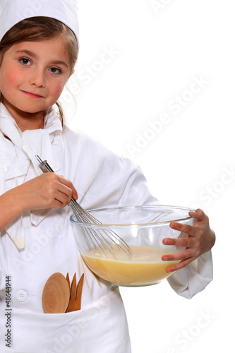 Photo: portrait of a little girl in baker clothes portrait of a little girl in baker clothes