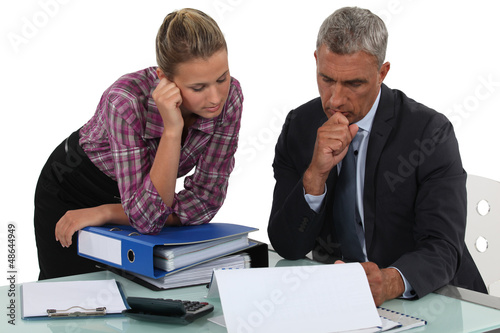 Photo: Boss explaining point to colleague Boss explaining point to colleague