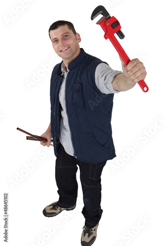 Photo: Worker with an adjustable wrench Worker with an adjustable wrench