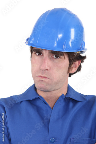 Photo: head-and-shoulders portrait of craftsman looking exasperated head-and-shoulders portrait of craftsman looking exasperated